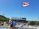 Volunteers Jeremy Dougherty, NS0S (left) and Bobby Price, KB4ROR, with their tape-measure beam and re-installed Puerto Rico flag. [Courtesy of Jeremy Dougherty, NS0S]